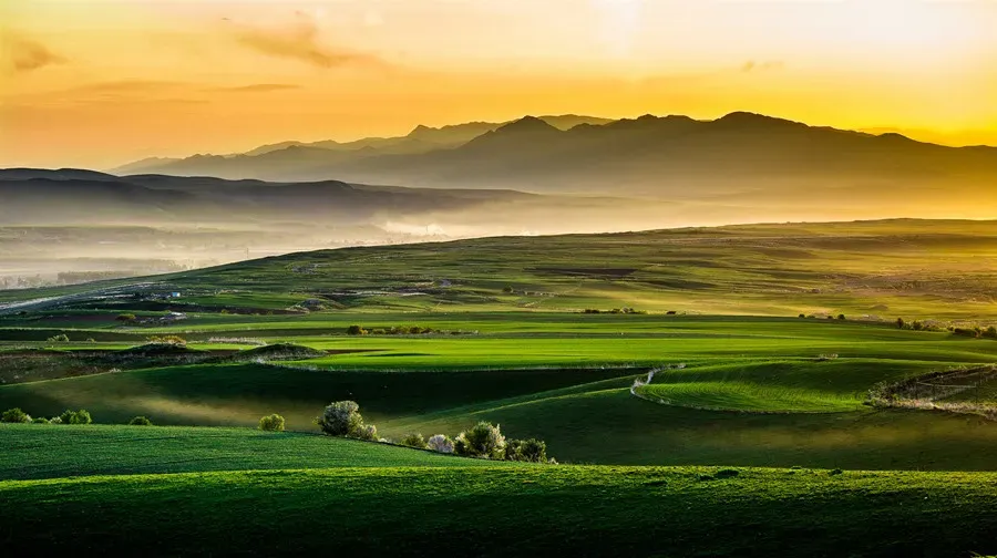 Nalati Grassland layered pasture glowing at sunset, Xinjiang