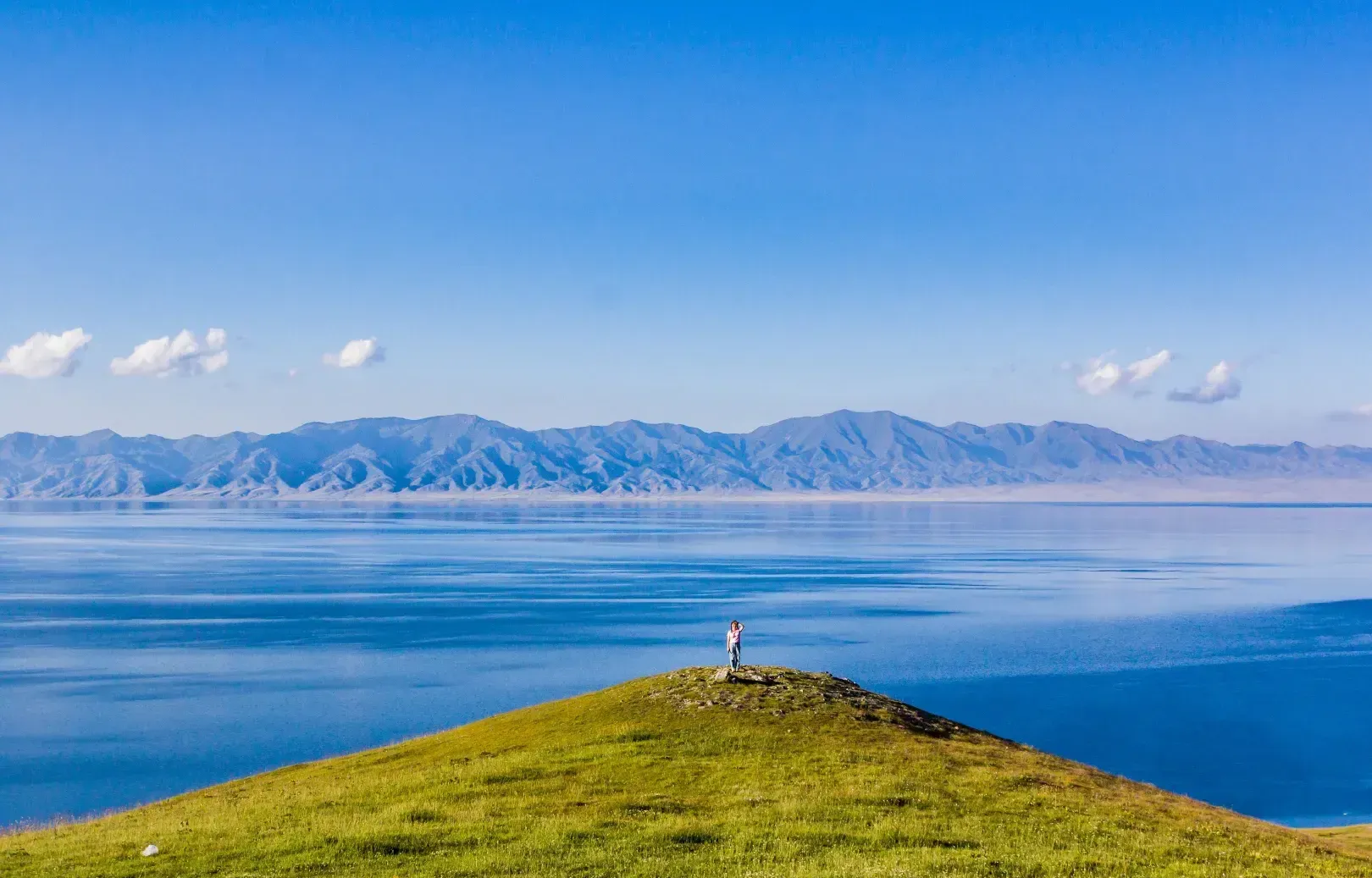 Sayram Lake Solitary Figure Hilltop Panorama, Xinjiang